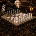 Handcrafted marble chess set on stone chessboard with grey and white pieces