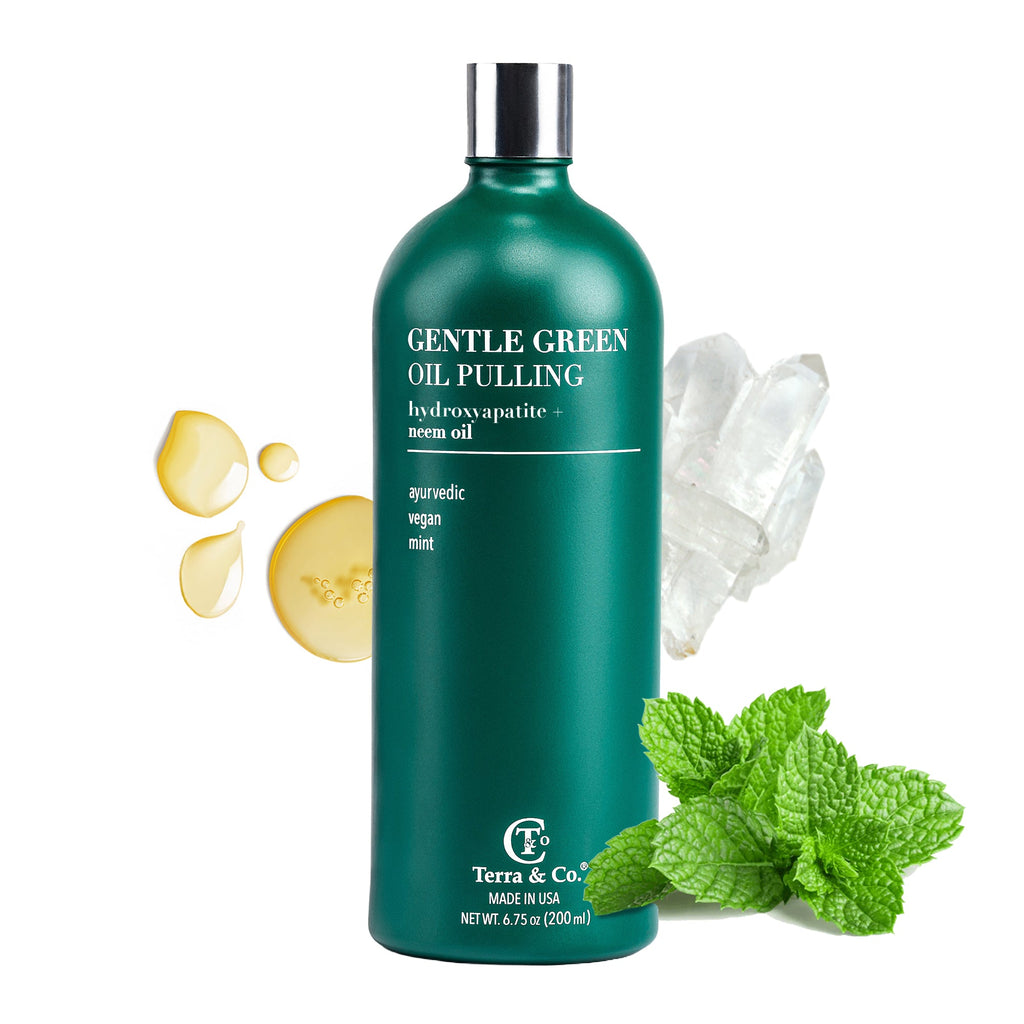 Gentle green oil pulling rinse bottle with cap, mint leaves, and oil droplets