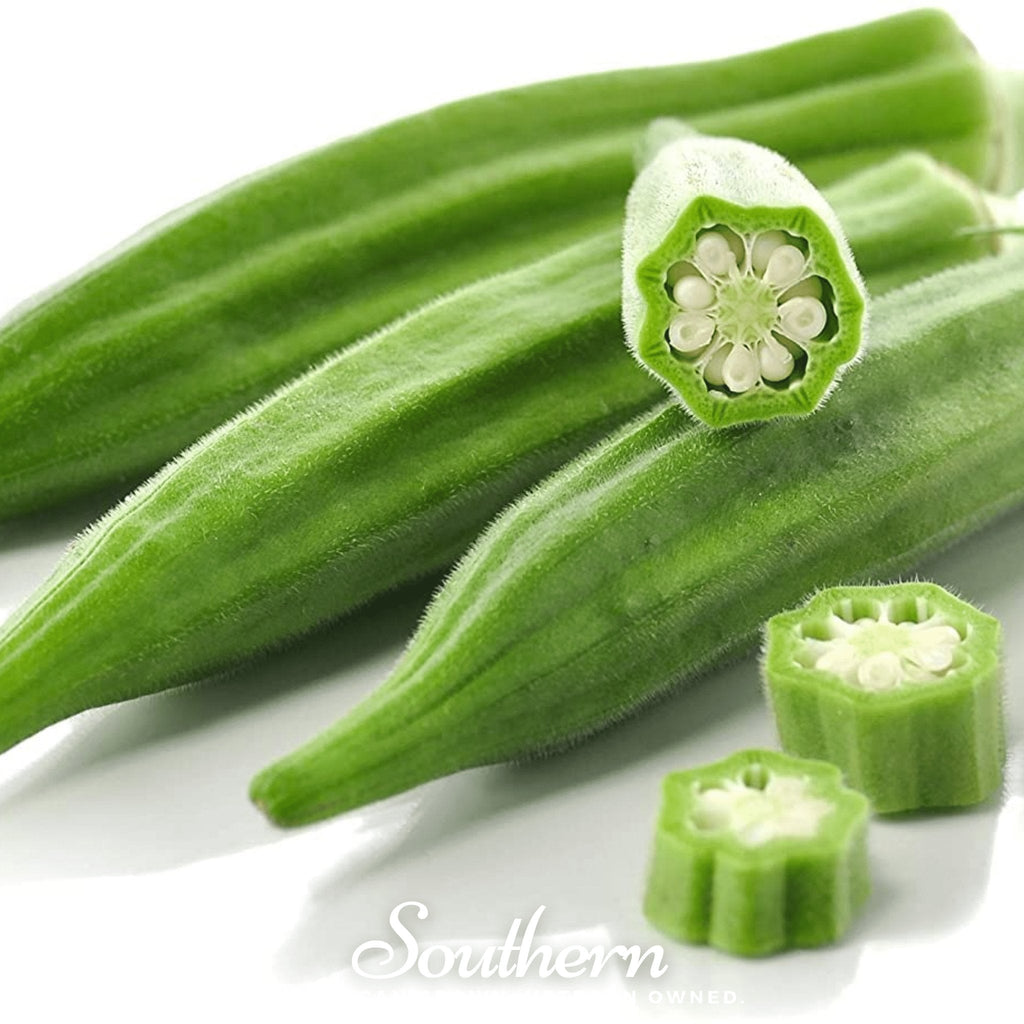 Green okra pods with cut cross-sections on a white surface