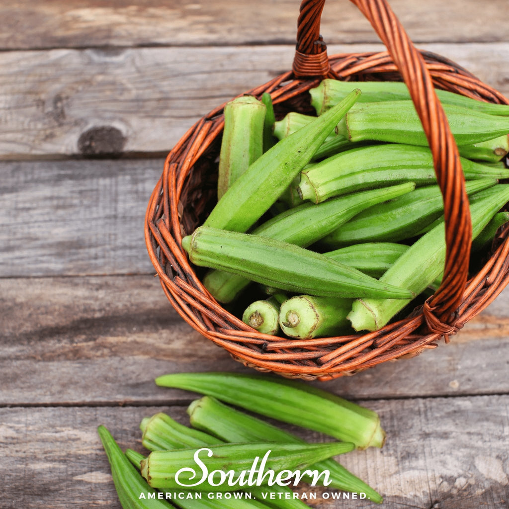 Basket of green okra pods with stems and unripe tips