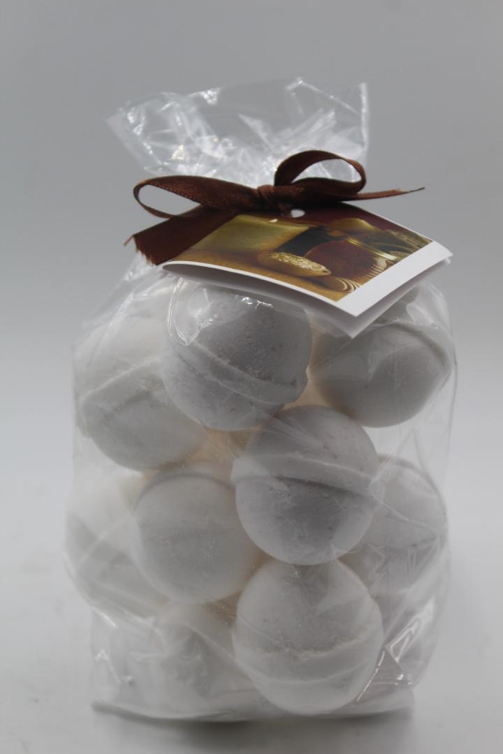 Bath bomb gift bag with round grayish-white bath fizzies, tied with brown ribbon