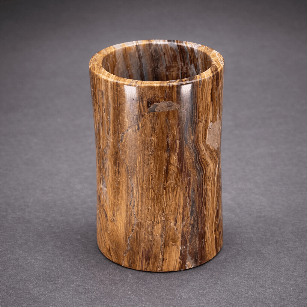 Brown onyx cylinder vase with vertical veining and open round top.