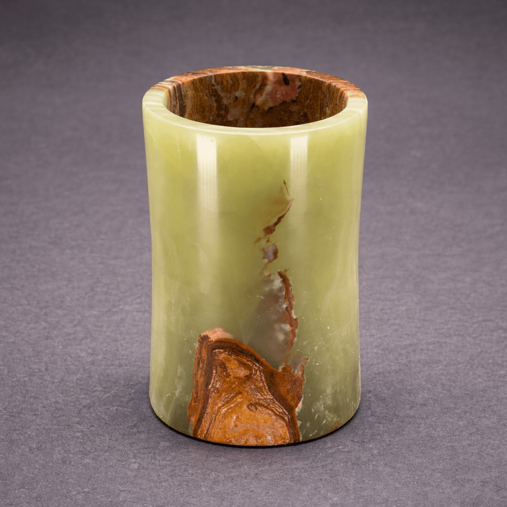 Green onyx cylinder vase with glossy finish, open round rim, and orange fissure.