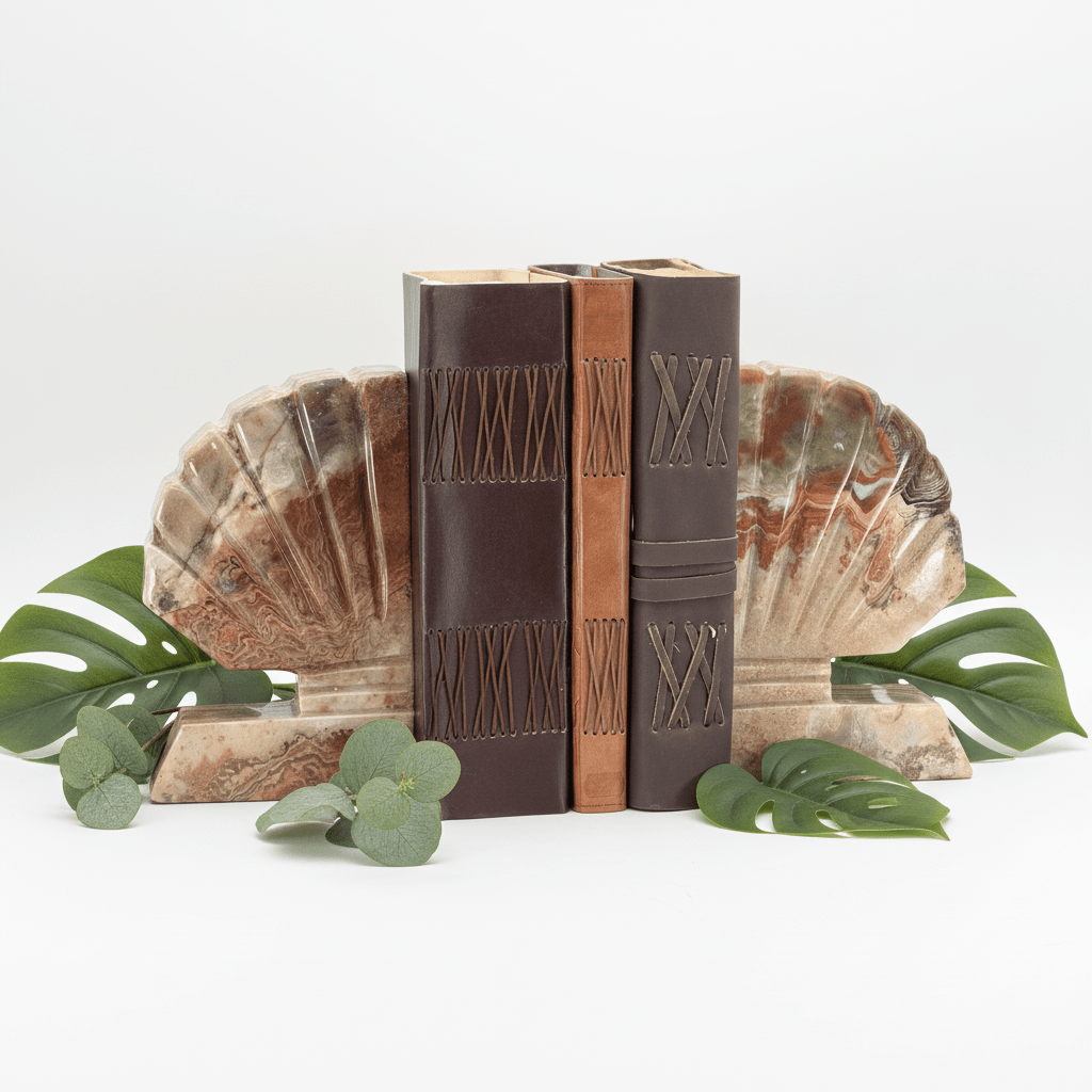 Gemstone shell bookends with upright brown books and carved geometric panels