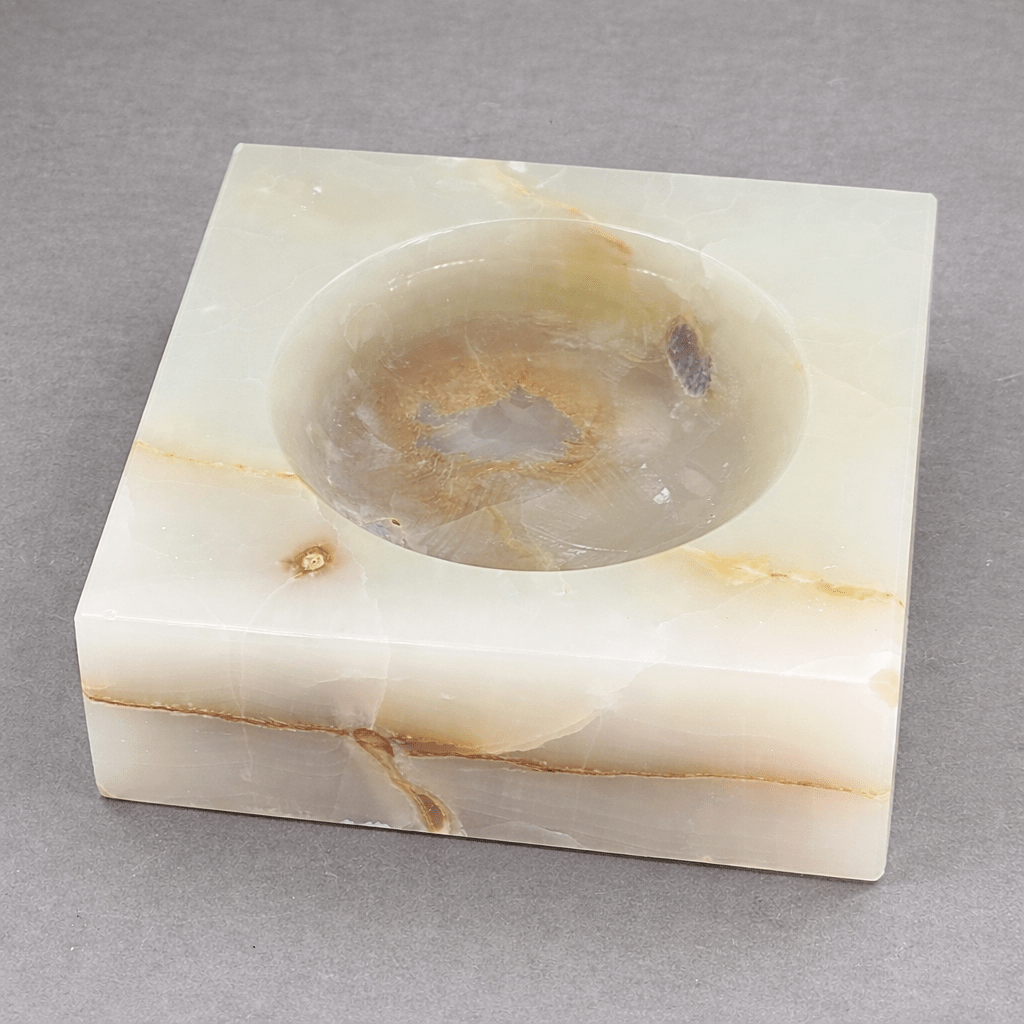 White square gemstone bowl with round recessed basin and speckled stone inclusions