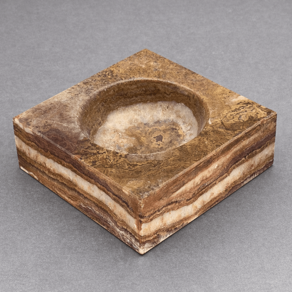 Brown square gemstone bowl with a round recessed basin and natural stone veining