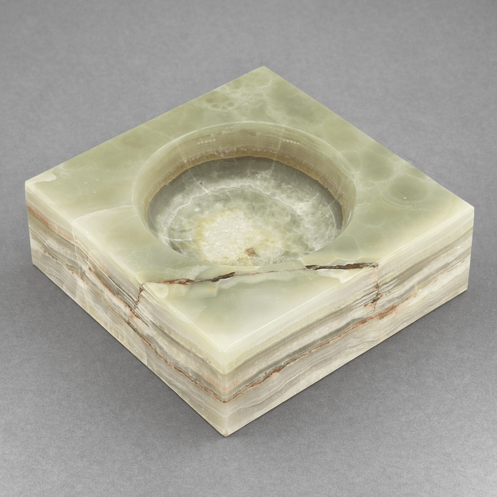 Light green square gemstone bowl with round recessed basin and marbled stone surface