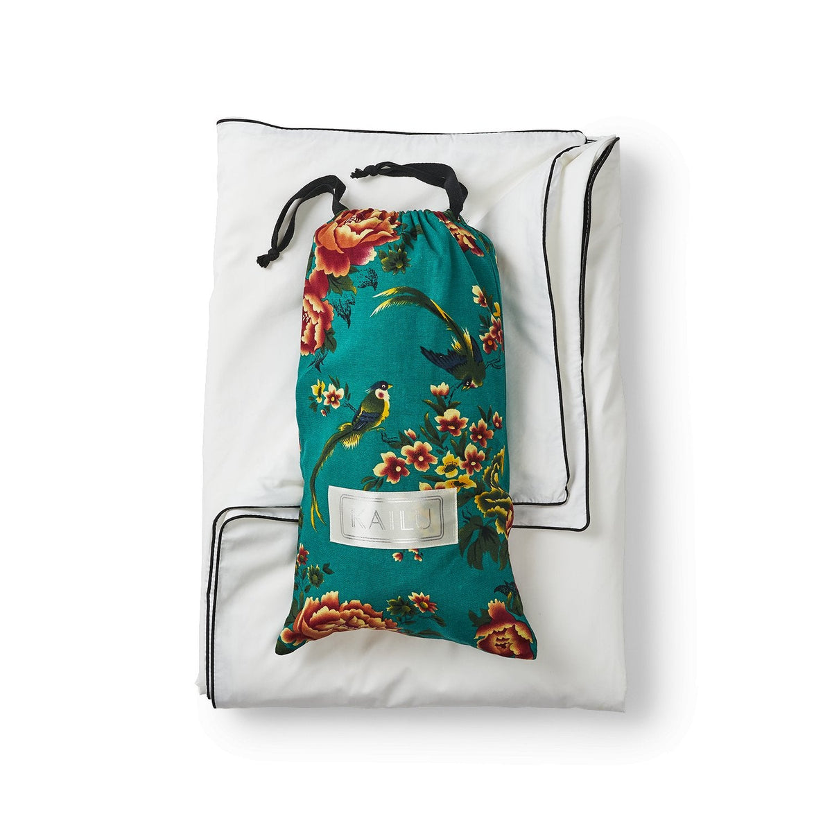 White silk throw cover with teal floral drawstring pouch inside.