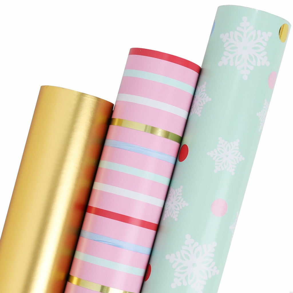 Christmas wrapping paper rolls: mint snowflake, pink stripes with gold accents, gold foil roll