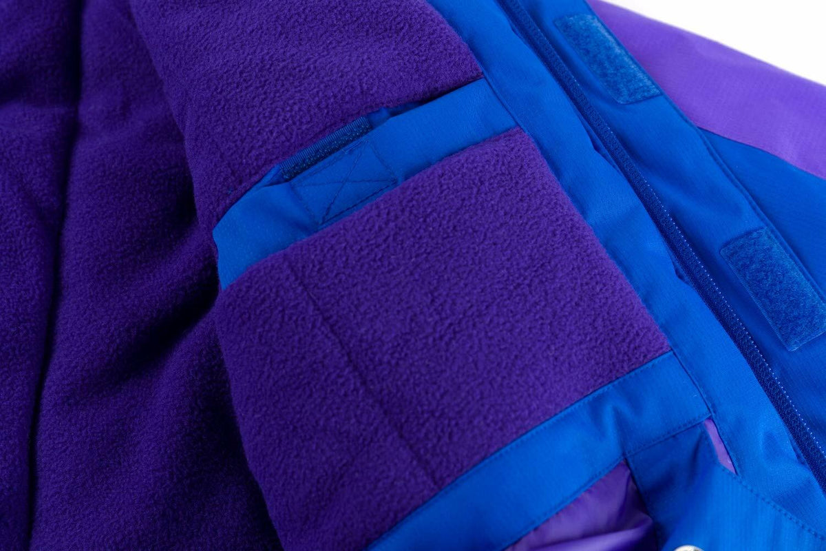 Fleece-lined blue and purple jacket sleeve with textured lining and stitched trim.