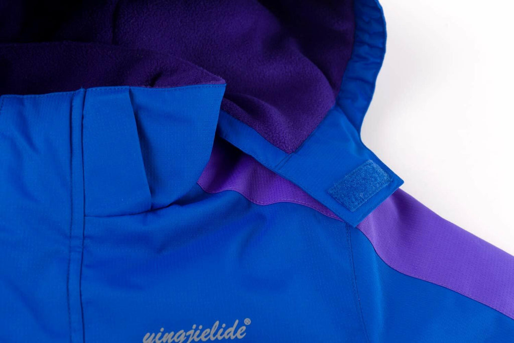Close-up of hood edge and front zipper on blue and purple waterproof ski jacket.
