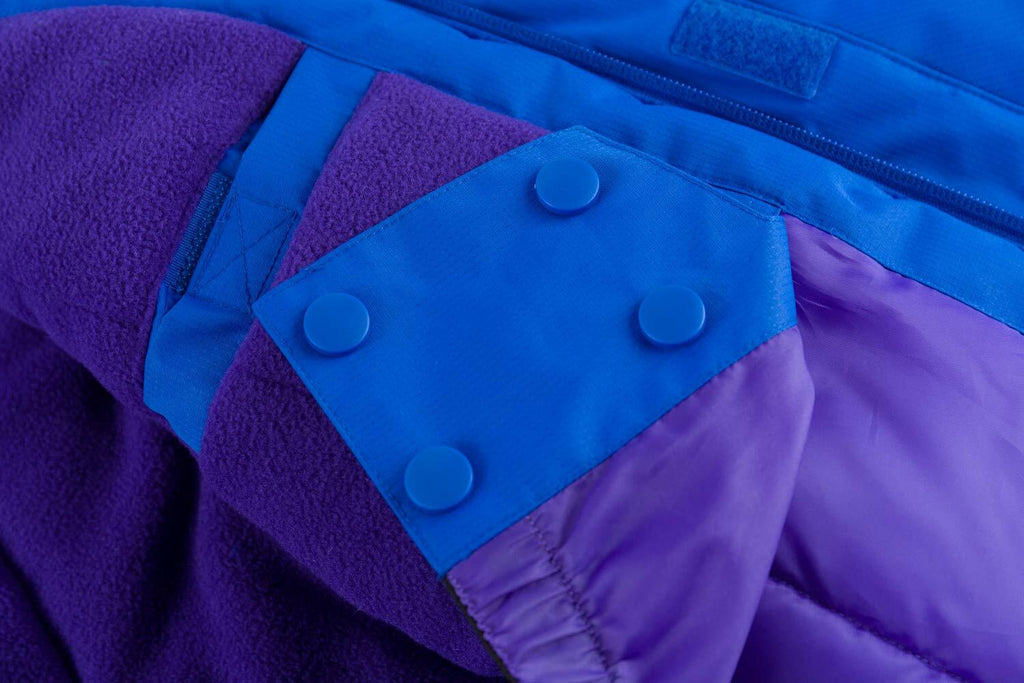 Fleece cuff detail on blue and purple waterproof ski jacket with snap buttons.