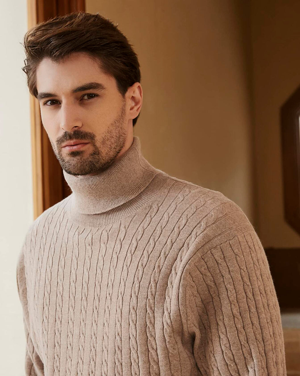 Men's wool-blend cable-knit turtleneck sweater, light tan, cable knit texture close-up.