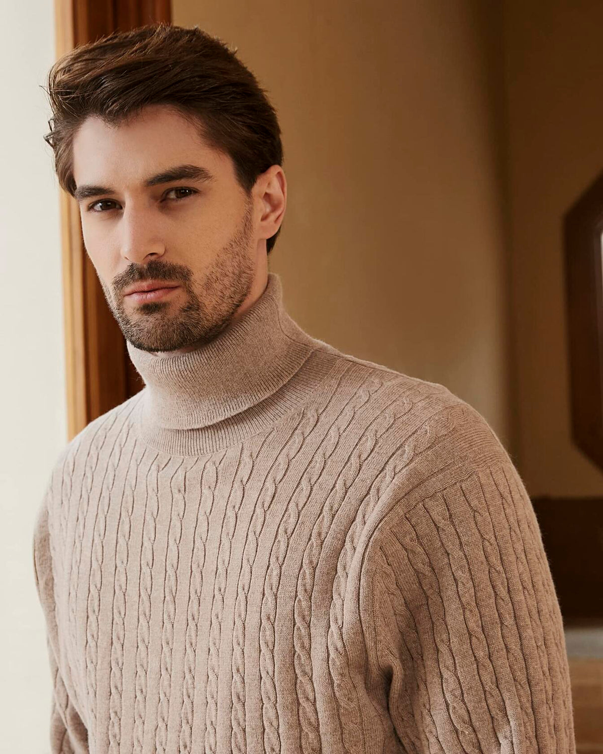 Men's wool-blend cable-knit turtleneck sweater, light tan, cable knit texture close-up.