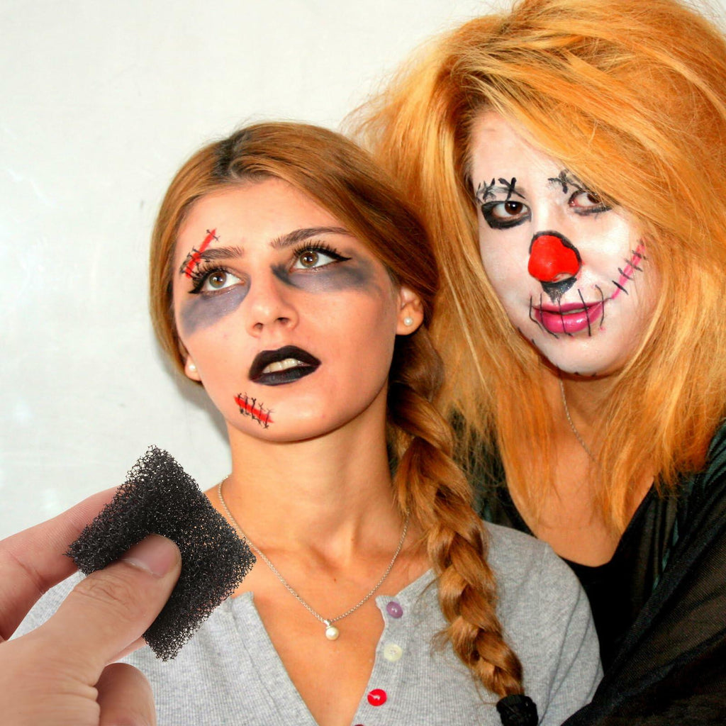 Black foam sponge held near painted faces for Halloween costume makeup