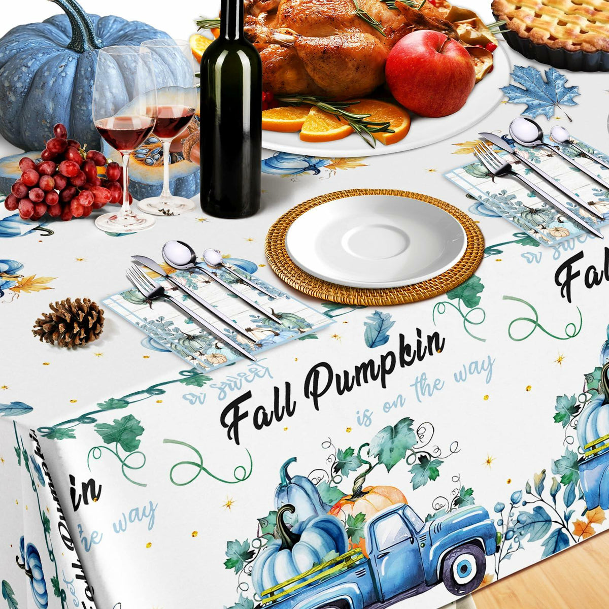Blue fall pumpkin tablecloth with truck and pumpkin motifs across the full table surface