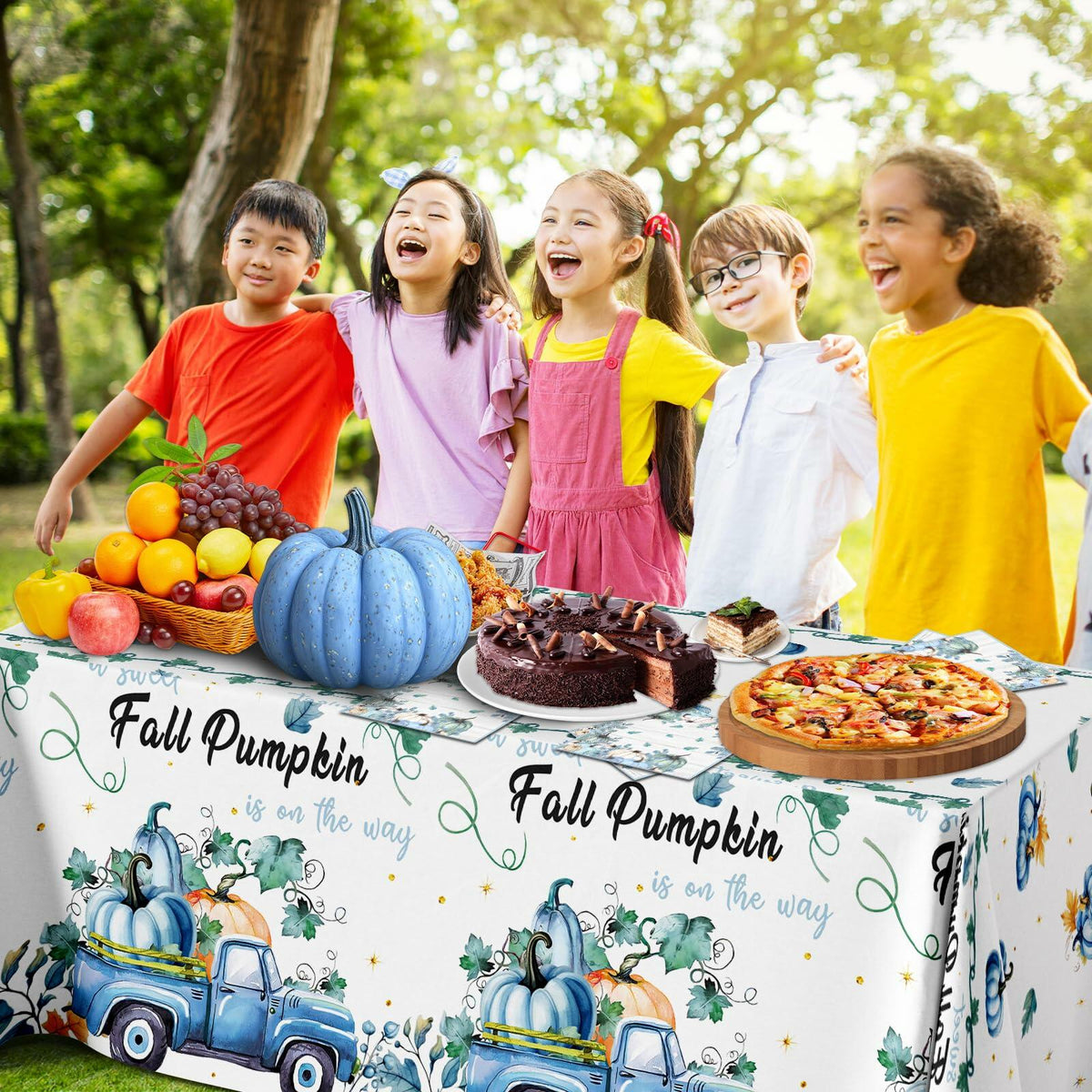 Blue fall pumpkin tablecloth with coordinated napkins around a party table centerpiece
