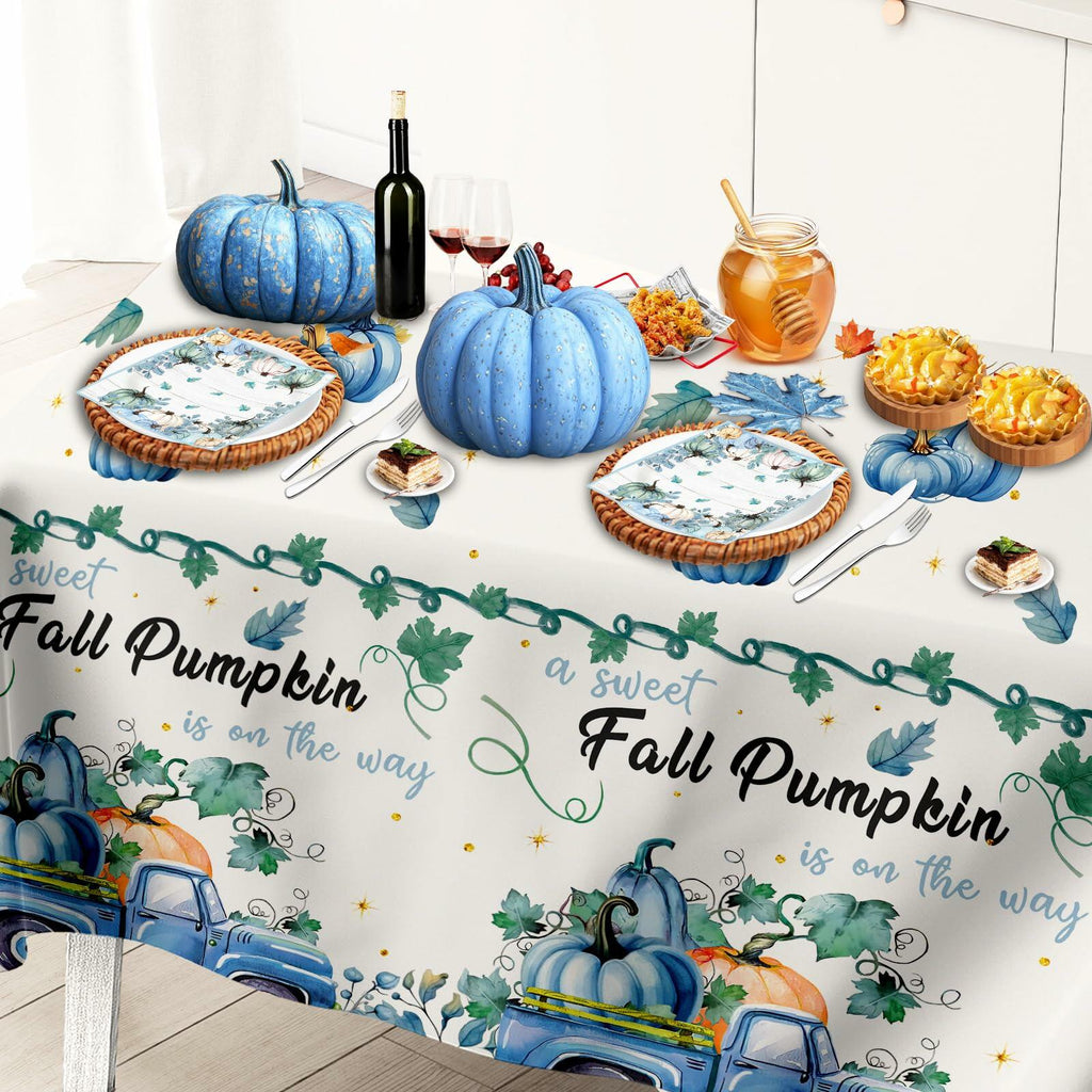 Blue fall pumpkin tablecloth featuring repeat truck and pumpkin prints with stacked napkins