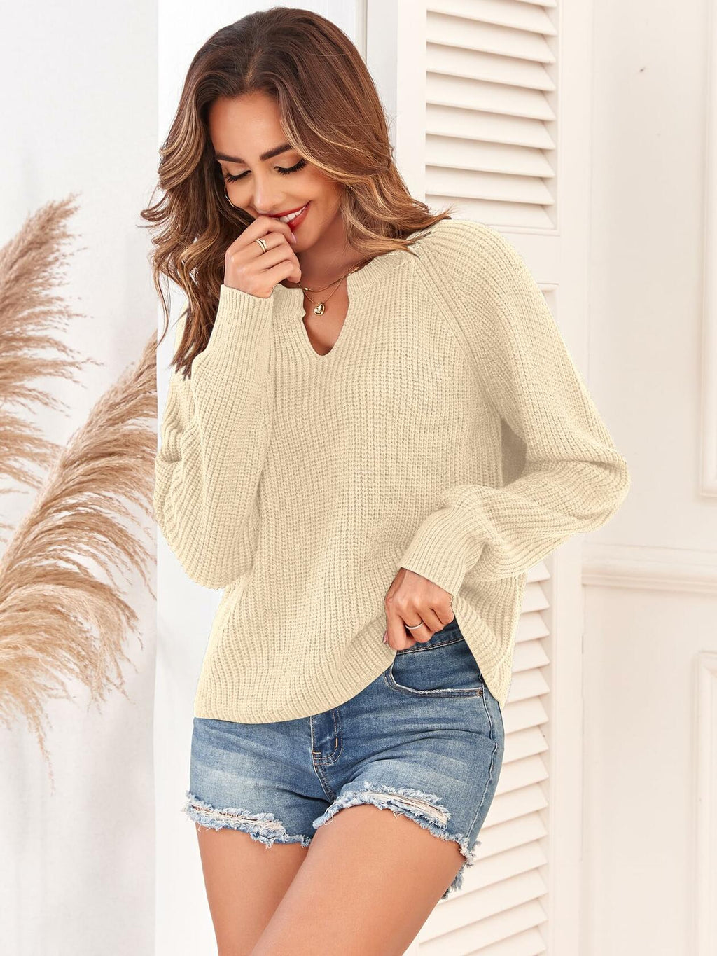 Ribbed knit V-neck long-sleeve sweater, light beige, side view with cuffs.