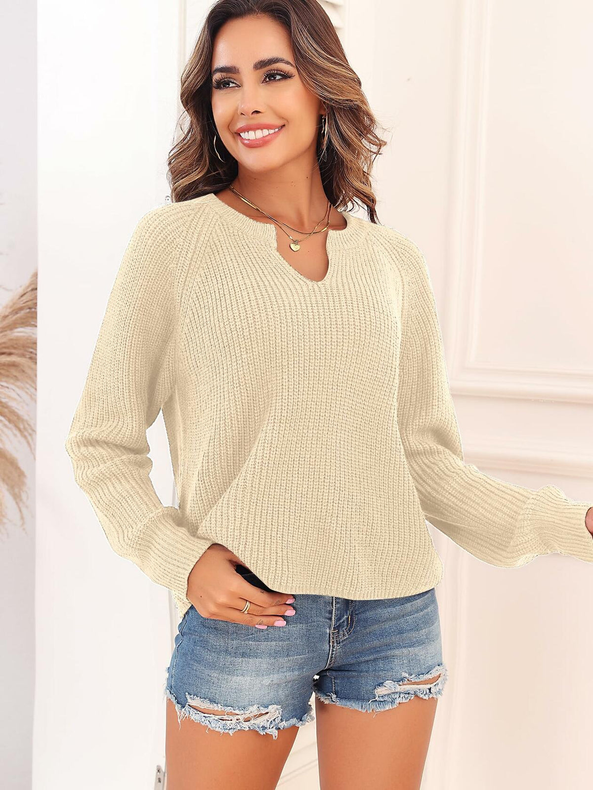 Ribbed knit V-neck long-sleeve sweater in light beige, front view with neckline.