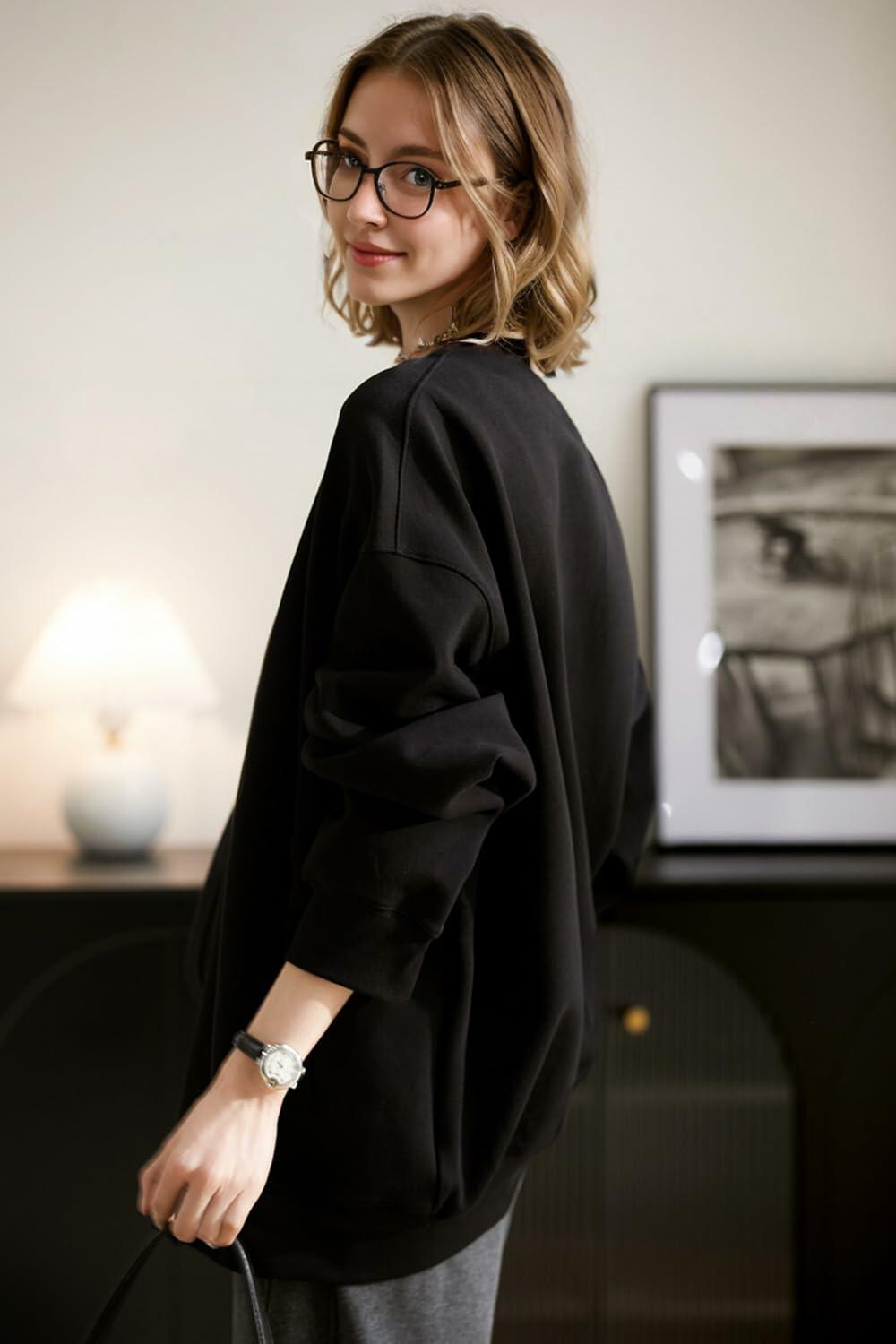 Black open-front hoodie coat with hood and long sleeves in relaxed fit