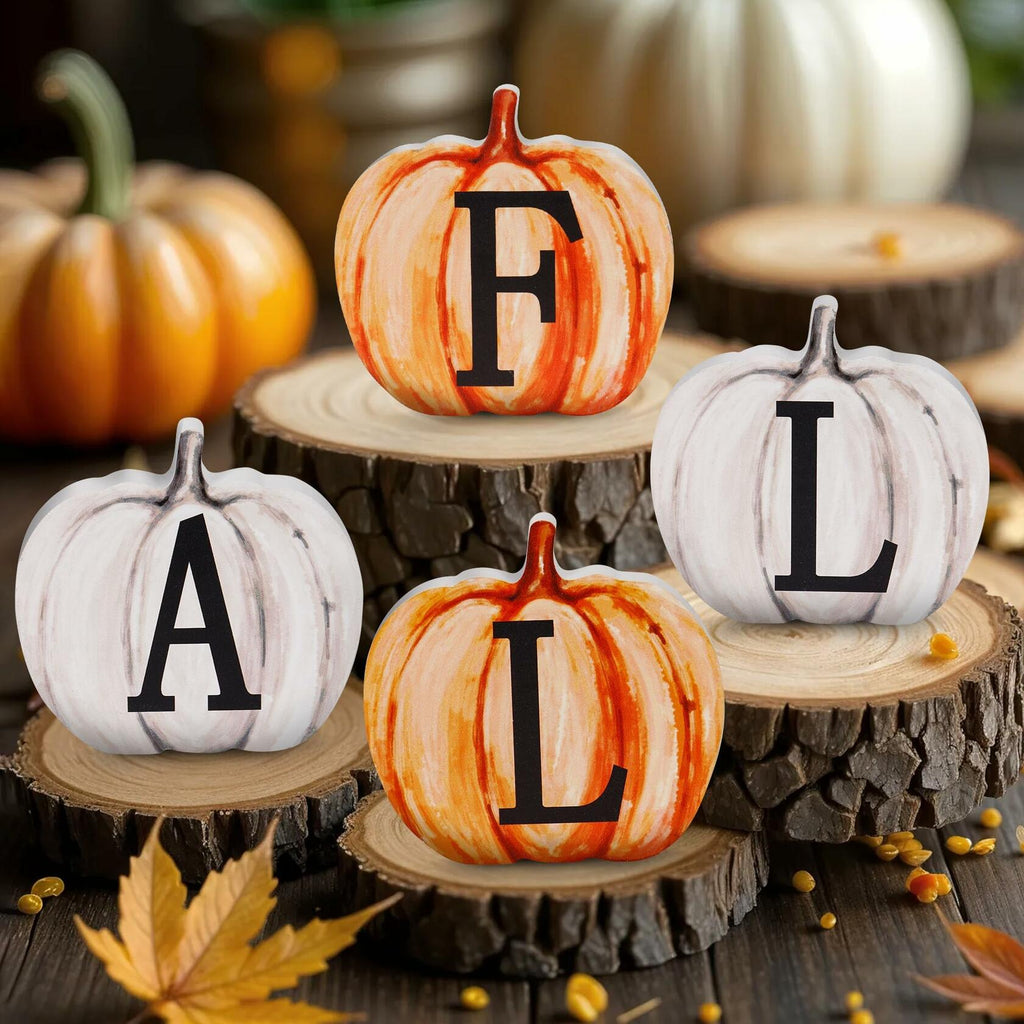 Four self-standing pumpkin wood letter signs on round stumps: F, A, T, L