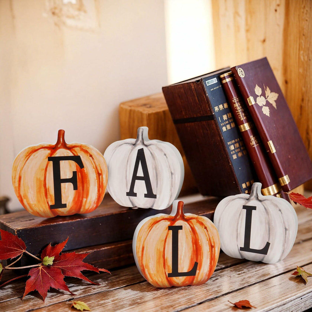 Four pumpkin wood letter signs arranged on a wooden shelf: F, A, T, L