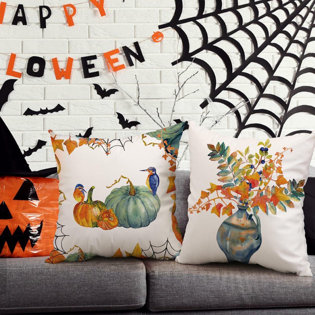 Two autumn pillow covers with pumpkin-and-leaf illustrations and bird details on white