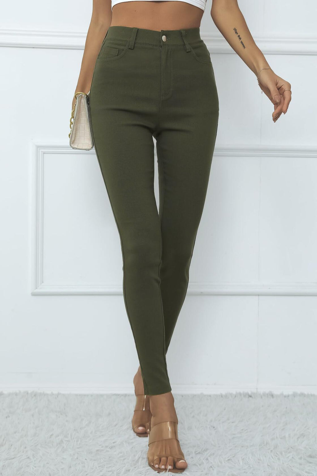 High-waisted army green skinny jeggings with front pockets and slim ankle fit