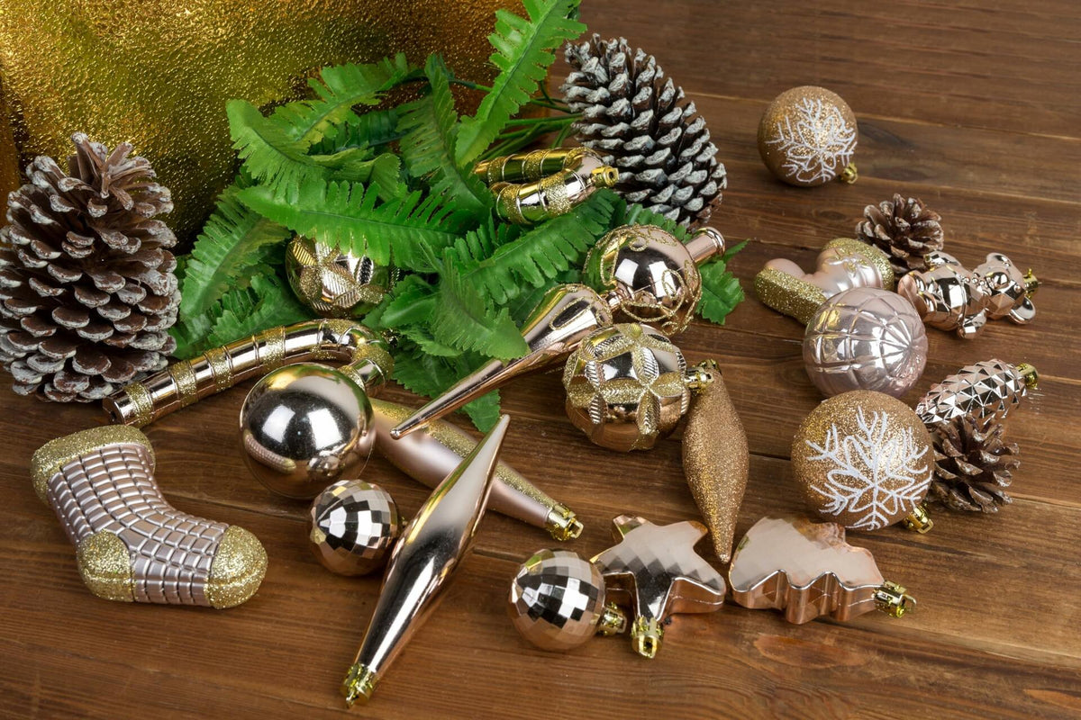 Assorted Christmas ornament baubles with pine cones, stars, and metallic gold accents