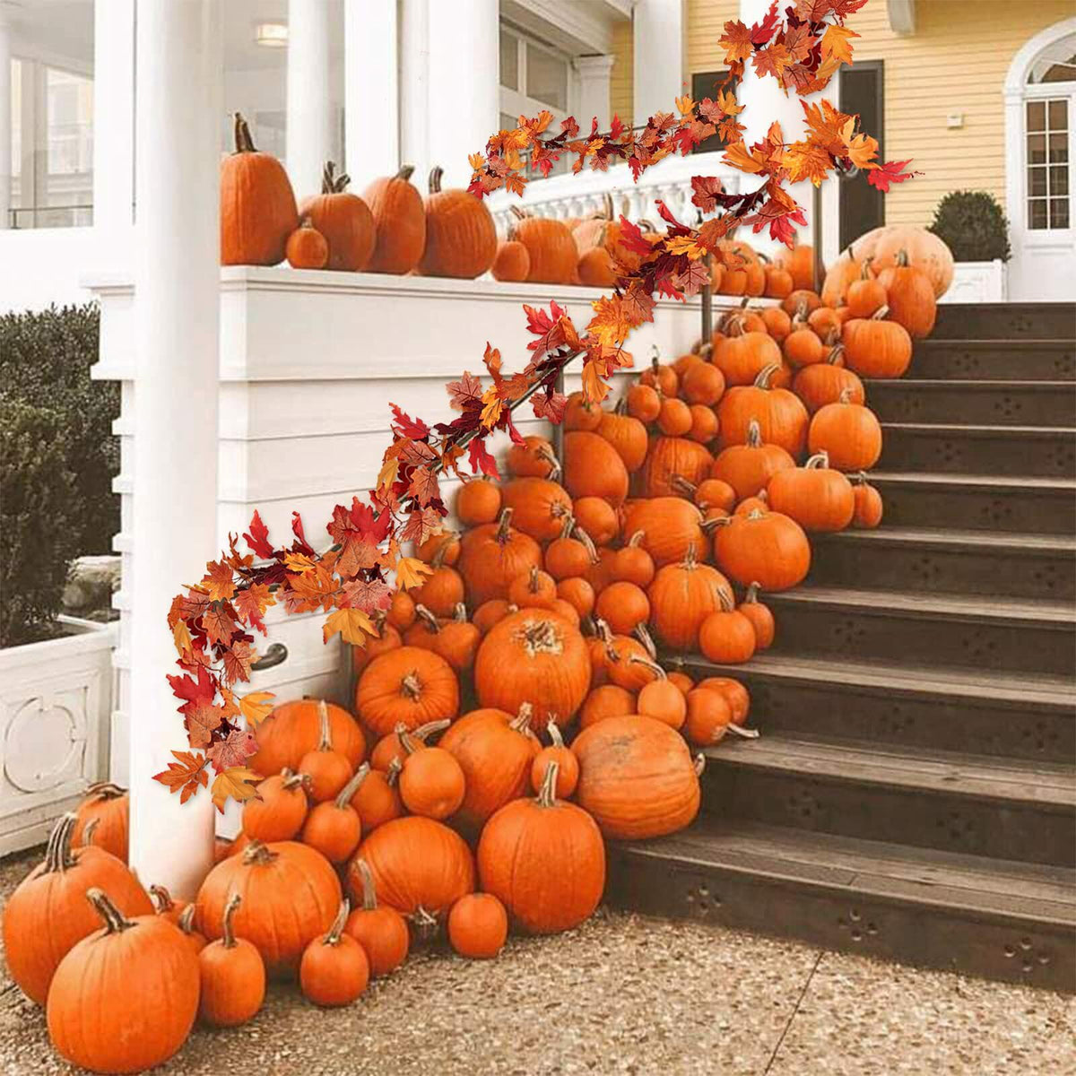 Outdoor fall maple leaf garland arch with orange and red artificial leaves