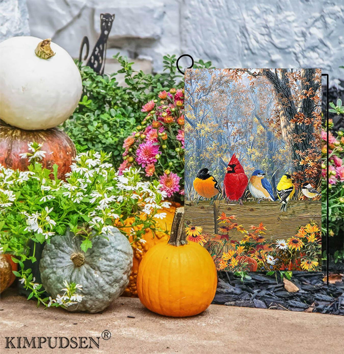 Double-sided garden flag with cardinal birds and autumn flowers beside pumpkins