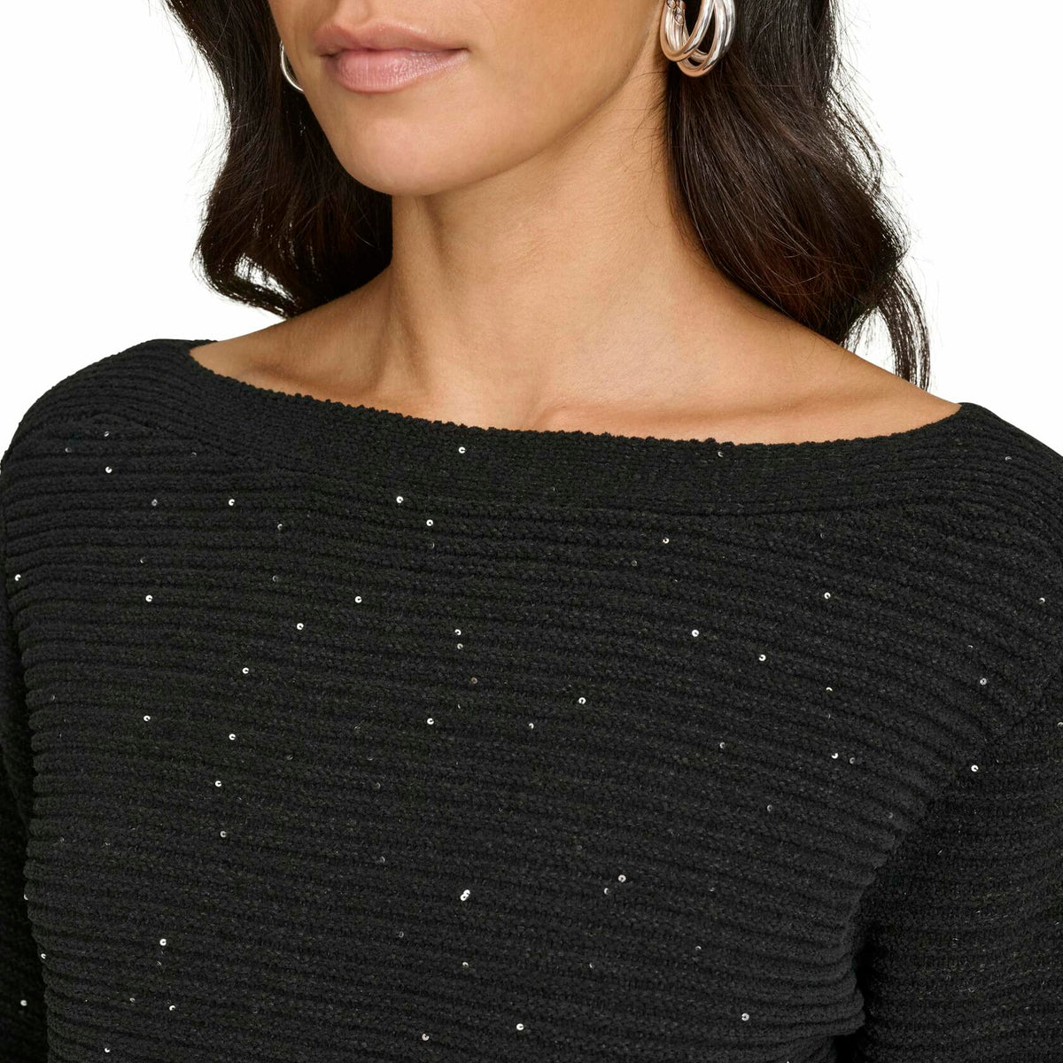 Close-up of women’s black knit sweater with scattered rhinestone-like specks
