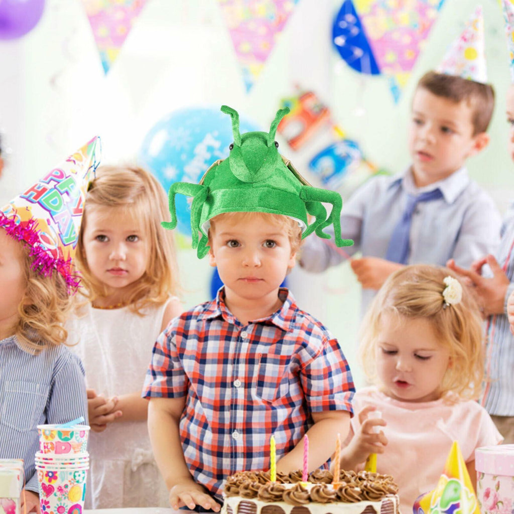 Plush green frog costume hat with beige ear panel, worn on a child's head