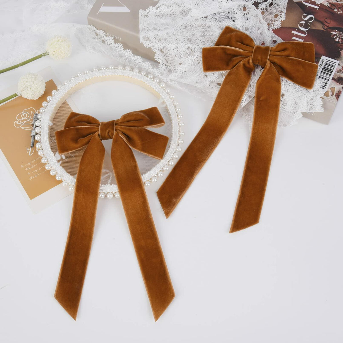 Brown velvet bow hair alligator clip with long ribbon tails, flat lay