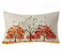 Autumn tree scene lumbar pillow cover with red and orange foliage and birds