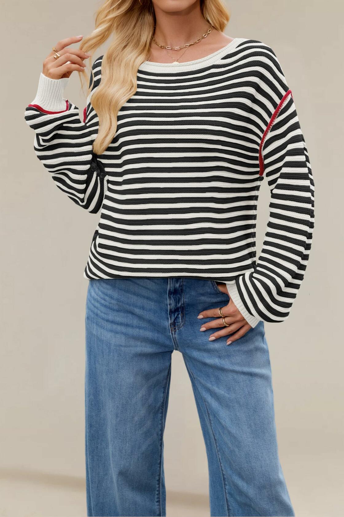 Black-and-white striped oversized boat-neck sweater with red-trim cuffs and ribbed hem