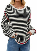 Black-and-white striped oversized boat-neck sweater with red-trim cuffs and hem