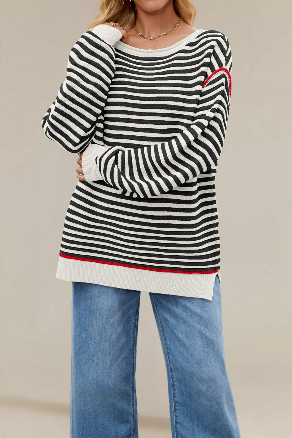 Black-and-white striped oversized boat-neck sweater with red-trim cuffs and ribbed hem