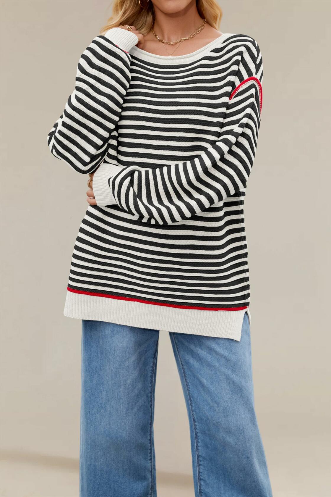 Black-and-white striped oversized boat-neck sweater with red-trim cuffs and ribbed hem