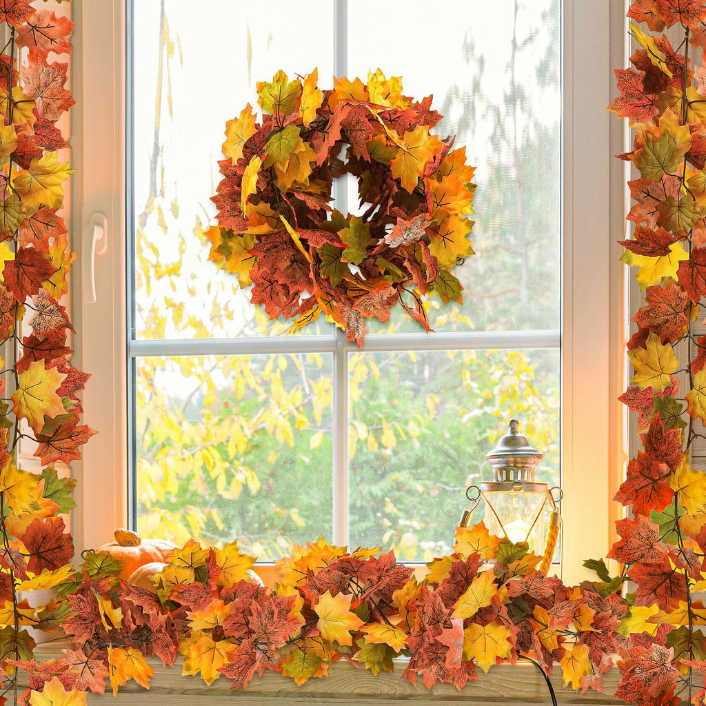 Artificial maple leaf garland border with orange and yellow leaves around window
