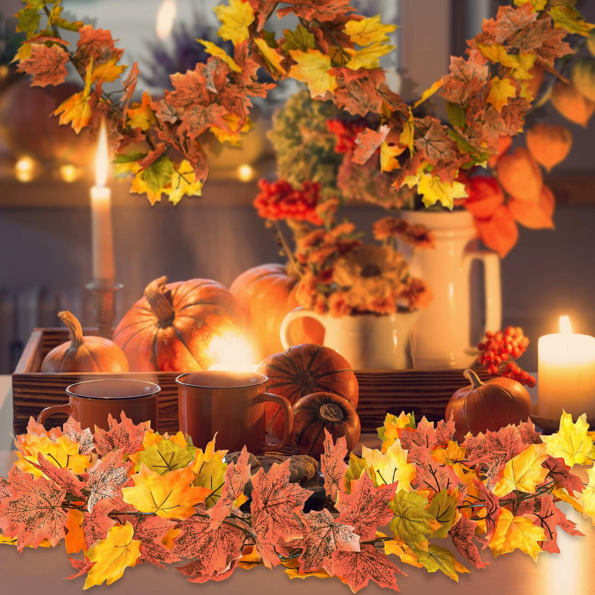 Artificial maple leaf garland with mixed orange, red, and yellow leaves across tabletop