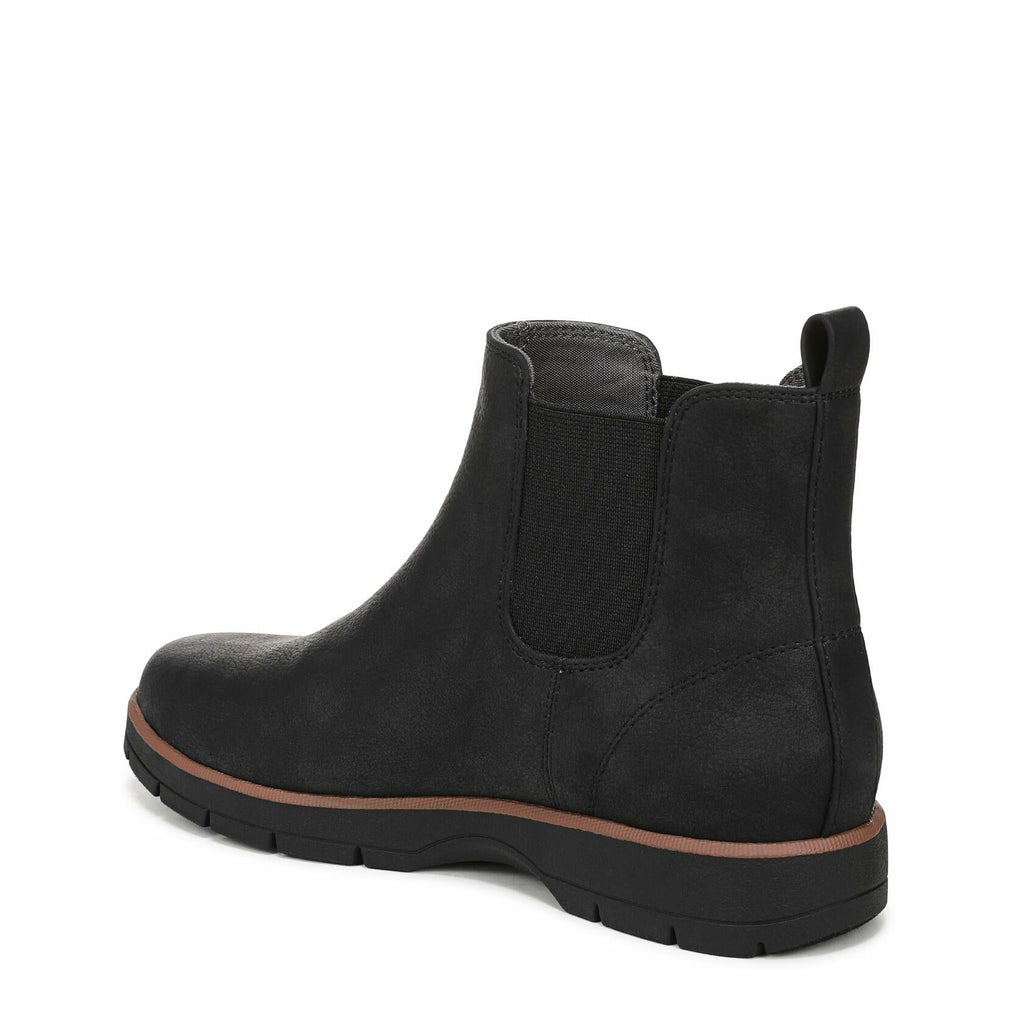 Black ankle boot with elastic gore panels and tan edge trim on rubber sole