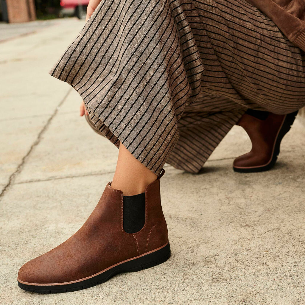 Dark brown ankle boot with elastic side gore and low rugged tread sole