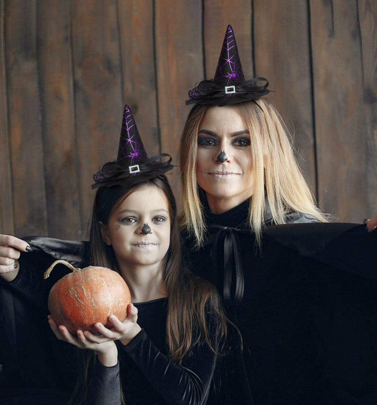 Purple witch hat headband with black bow and elastic band, worn on two heads