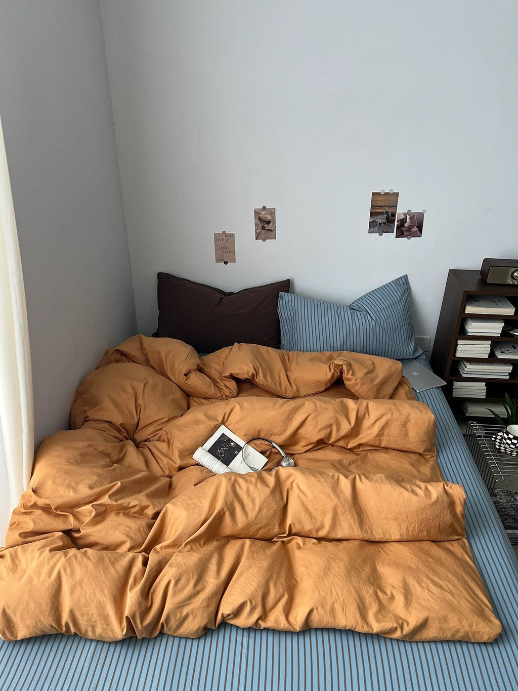 Orange bedding set with fitted look duvet and two pillows, plus one dark pillow