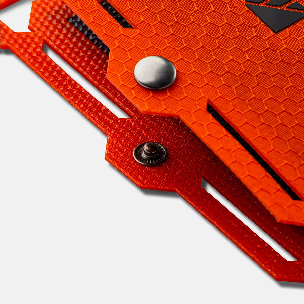 Orange textured solar panel surface with metal snap button and riveted details