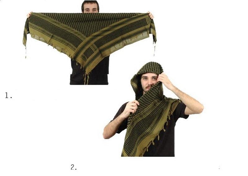 Olive green keffiyeh-style scarf with border stripes, worn as a head wrap
