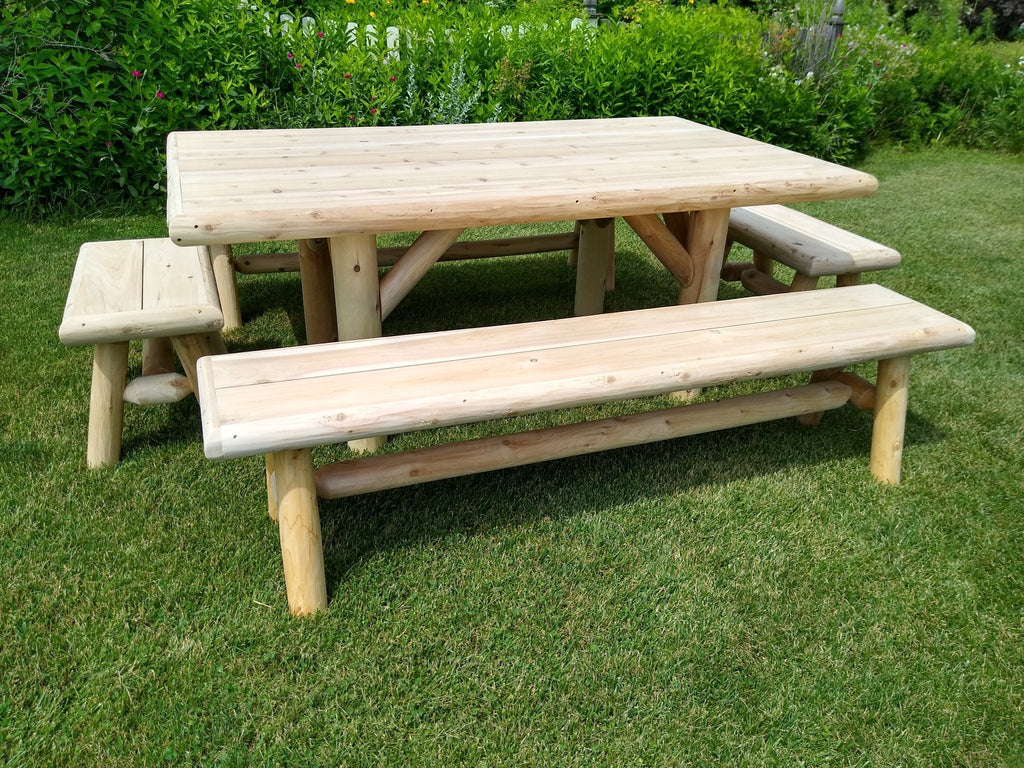 Outdoor picnic table with two benches, front view, light wood slatted seats on grass