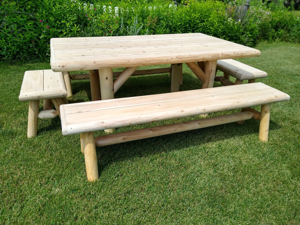 Outdoor picnic table with two benches, light wood tabletop and slatted bench seats